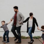 Families - Family Of Four Walking At The Street