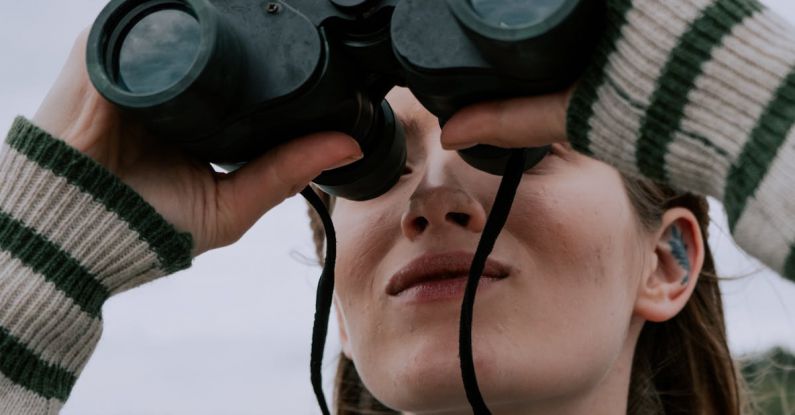 Ecotourism - A Woman Looking Through Binoculars