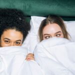 Best Time - Two Young Girls Lying on White Bed