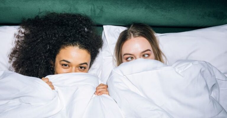 Best Time - Two Young Girls Lying on White Bed